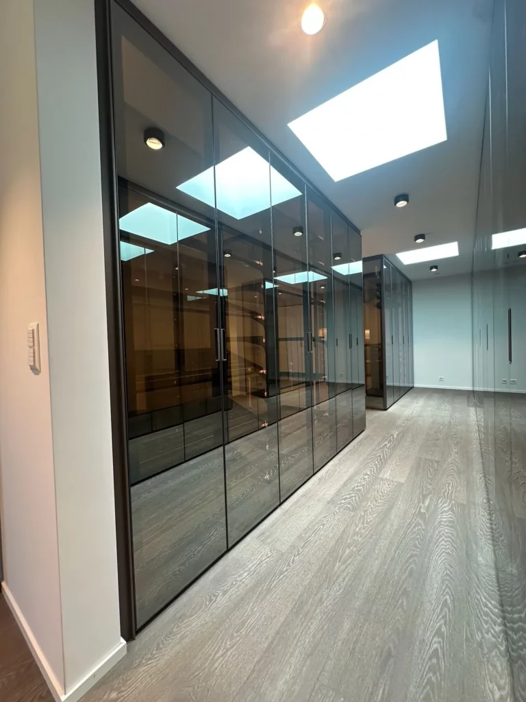 Ankleidezimmer mit Glaswänden und Beleuchtung